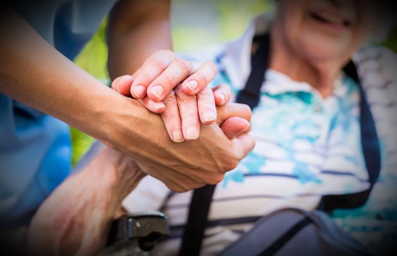 Caring hands holding together representing support and care
